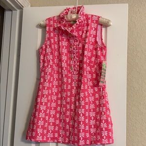 Pink golf shirt with frill collar.